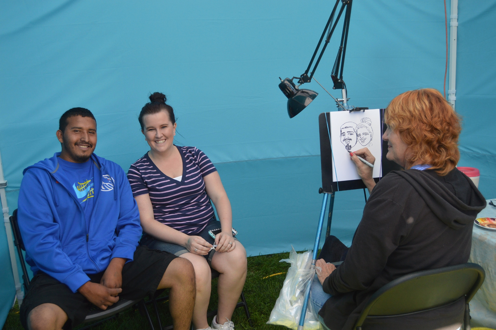 Couple having caricatures sketched